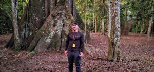 Man standing in front of sacred tree